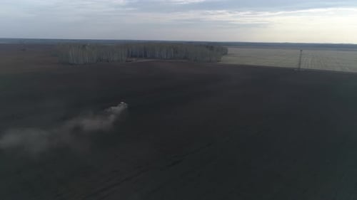 Tractor plow in a huge field, Spring, evening 06