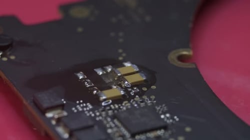 Close Up View of Electronic Renovation in Repair Shop Treplaces an Electrical Part in the