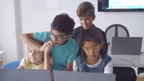 Focused Naughty Pupils Sitting and Standing at Desk