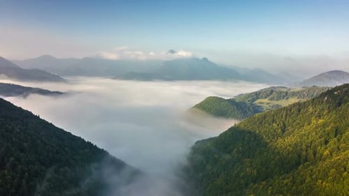Fly above Foggy Clouds in Mountains Valley