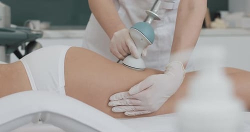 Healthcare Worker Treating Skin with Device