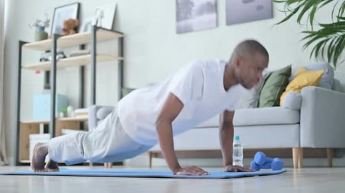 Man Doing Push Ups on Yoga Mat Indoors