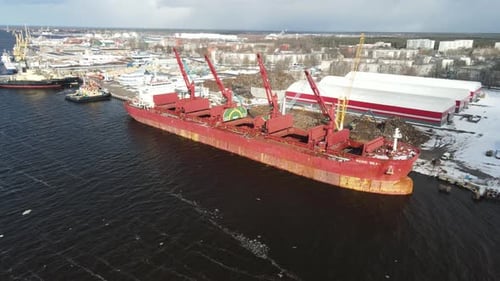 Cargo Ship in City Port Loaded with Scrap Metal