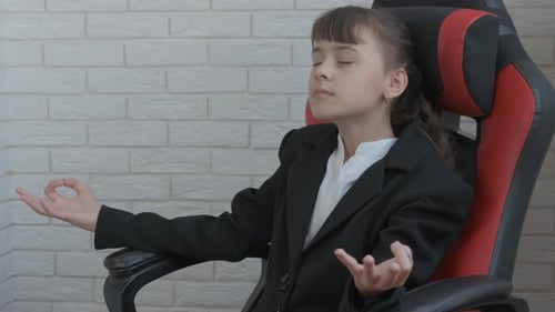 Girl Meditating in Gaming Chair Wearing Business Suit