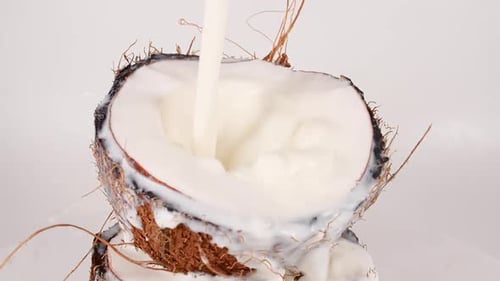 Milk Poured onto Fresh Coconut