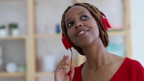 Young Woman Listens to Music with Headphones