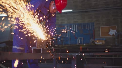 Worker Using Power Tool in Factory Setting