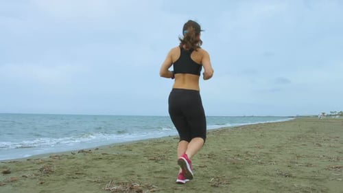 Woman Running on Beach for Fitness Training