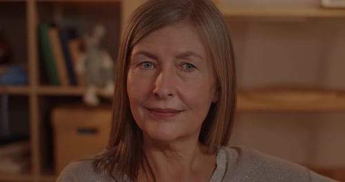 Close Up View of Mature Pretty Woman with Blond Hair Watching Film