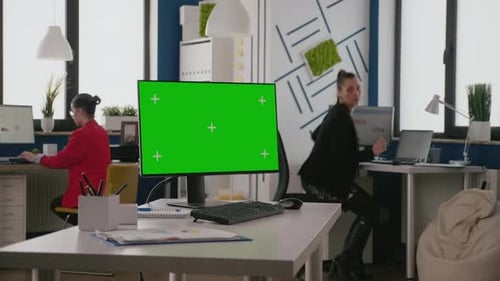 Close Up of Empty Desk with Green Screen on Computer