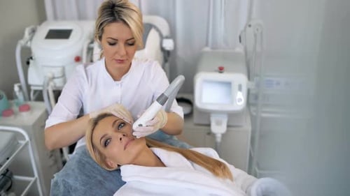 Woman Receiving Professional Facial Treatment at Medical Spa