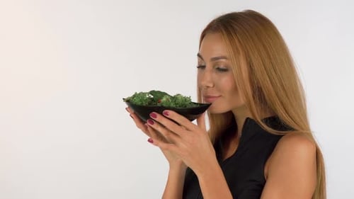 Woman with Salad Smelling Food