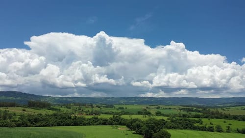Expansive Green Landscape with Dramatic Clouds