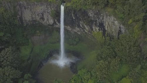 Aerial View of Majestic Waterfall in Green Nature