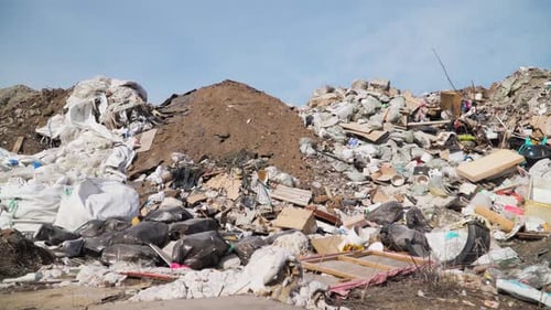 Pile of Garbage in Landfill Under Blue Sky