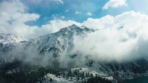 Snowy Mountain Range with Clouds Aerial View