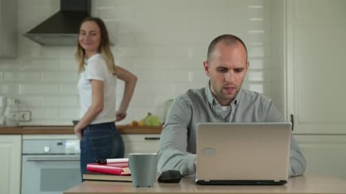 Couple Working Together at Home in Kitchen