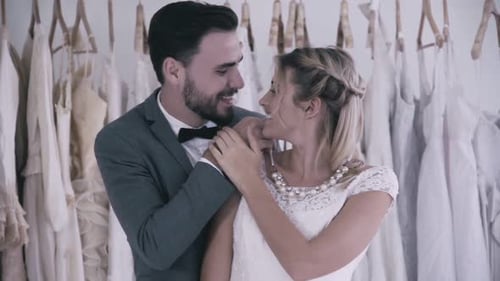 Romantic Couple Choosing Wedding Dress in Bridal Shop