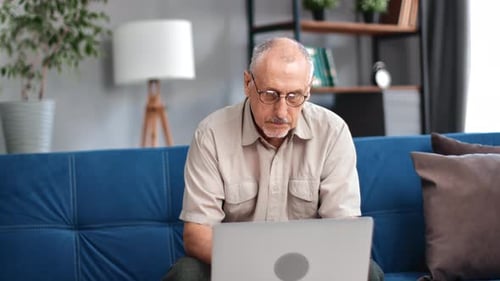 Man Working on Laptop Computer at Home