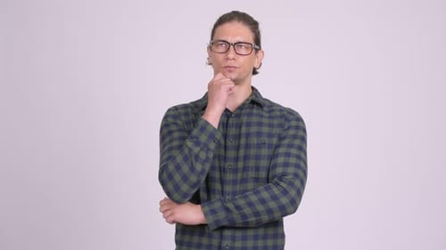 Pensive man in shirt thinking with hand on chin