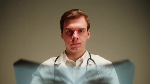 Doctor Examines Patient X-Ray Results