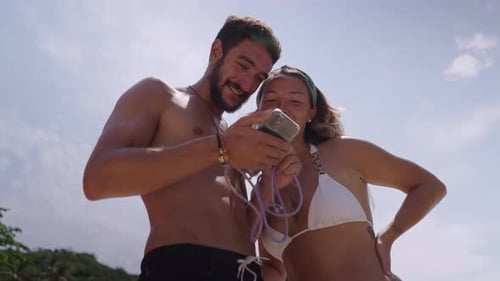 A Video of a Couple Enjoying Each Other Company While Standing on Beach