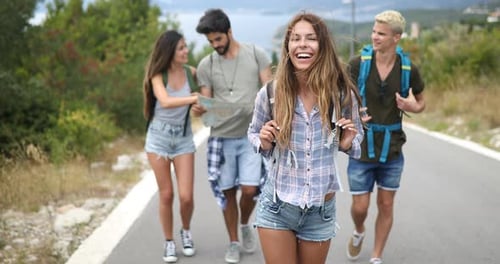 Friends Hiking Together on Rural Road Trip