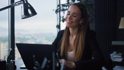 Businesswoman Using Laptop for Work in Office. Positive Girl Pointing at Screen