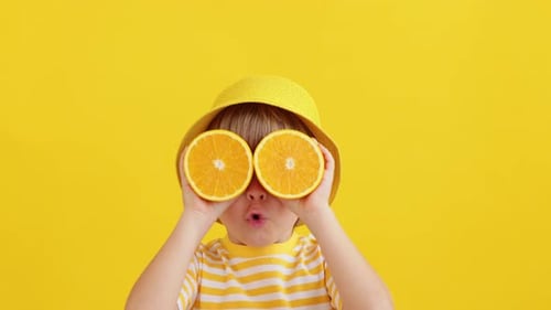Child With Orange Eyes on Yellow Background