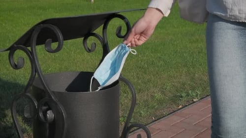 Woman Throws Medical Face Mask in Park Trash Can
