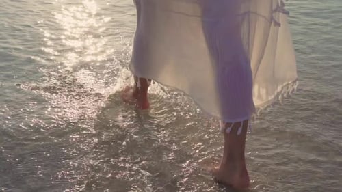 Beautiful female happy relax walking on beach near sea when sunset.