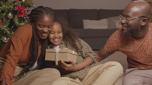 Happy Family Exchanging Christmas Presents