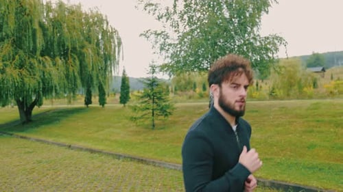 Man Jogging for Fitness in Scenic Park