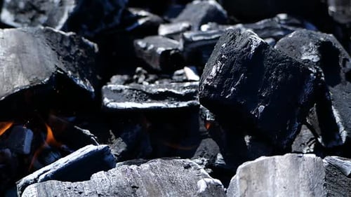 Wood Black Charcoal Burning on a Grill in Slow Motion