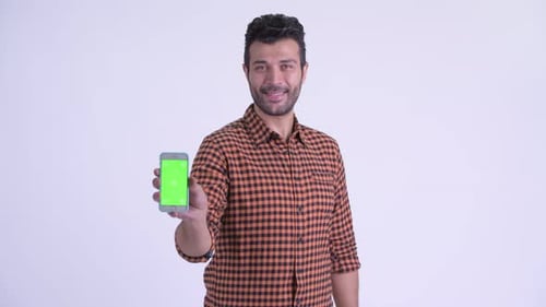 Smiling Man Presents Phone With Green Screen