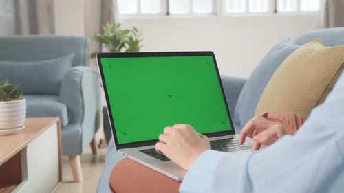 Female Working On Laptop With Green Screen Display