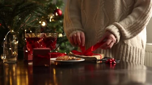 Present Wrapping by Christmas Tree at Home