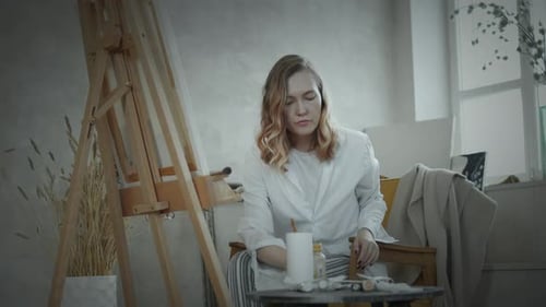 Woman Painting Art Indoors in a Bright Room