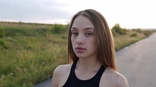 Portrait of Pretty Woman near Rural Road