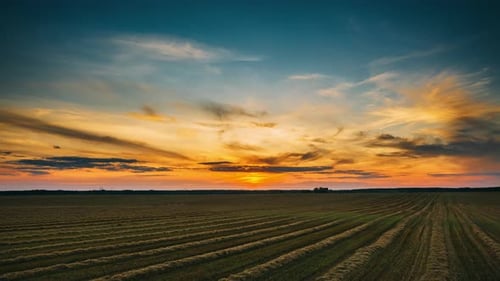 Aerial View Of Sunset Bright Sky Above Summer Hay Field Landscape In Evening