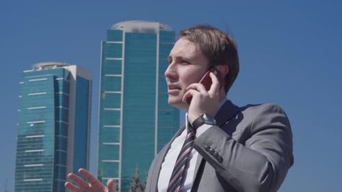 Businessman Talking on Phone in City Environment