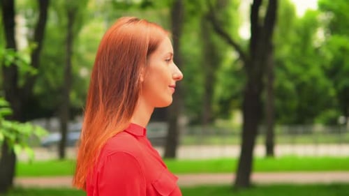 Red Haired Female Walking in Green Park