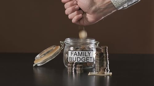 Saving Coins Into Family Budget Jar