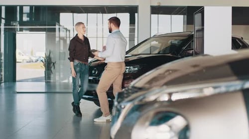 Customers Looking at Cars in Showroom