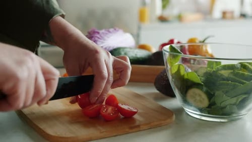 Hands Cut Fresh Tomatoes for Salad Preparation