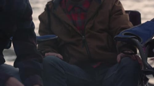 Panning down from two brothers faces to campfire
