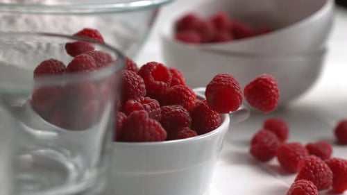Fresh Raspberries Poured Into White Serving Bowl