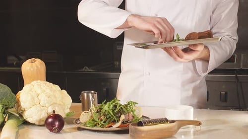 Chef Garnishing Salad in Bright Kitchen
