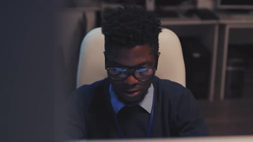 Black Man Working Late in Office