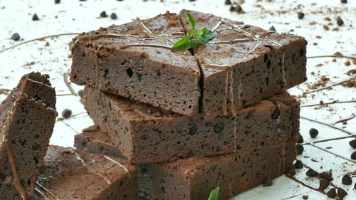 Stacked Chocolate Brownies Garnished with Mint Leaves